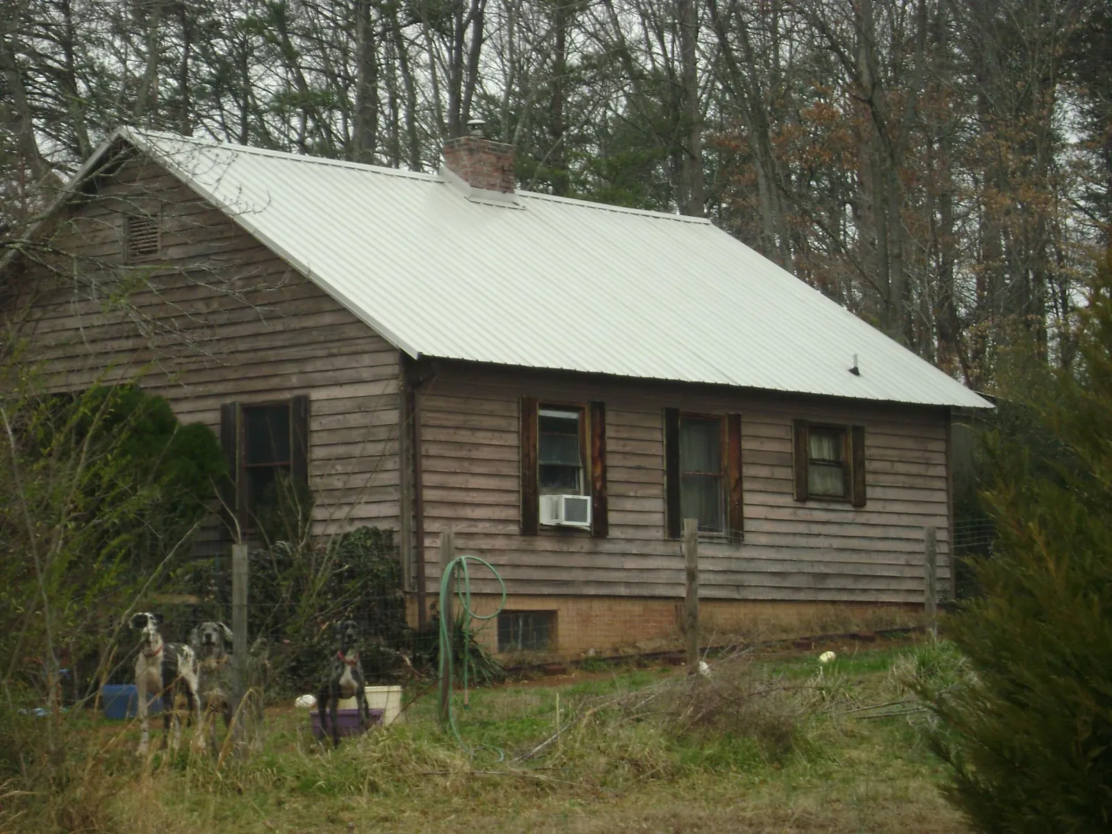 White metal roof on an old wood sided farmhouse, from a Metal Roof Installation job in Waterville Valley